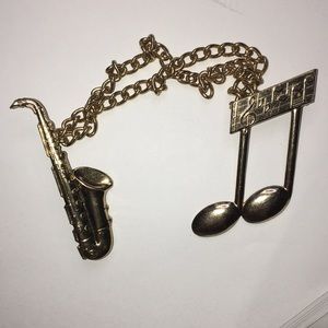Sweater or scarf holder, musical theme brooches